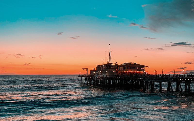 pier with waves at sunset