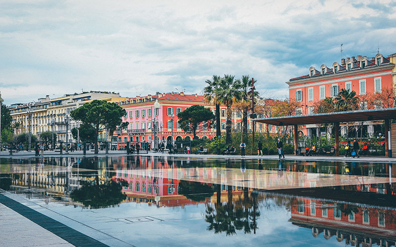 People walking along the path with fountains on it