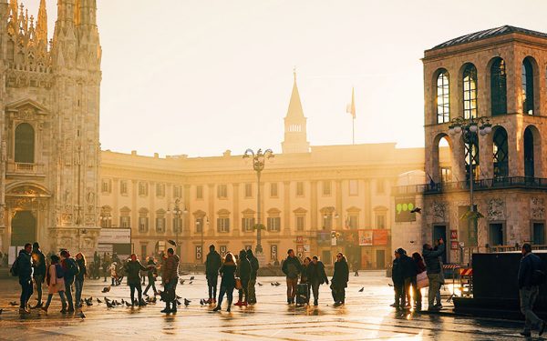 A busy town square with people and pidgeons