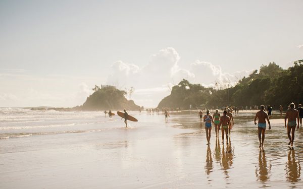 Surfers and beachgoers in Byron Bay