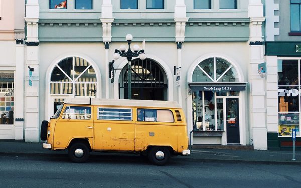 Yellow campervan parked on the side of the road