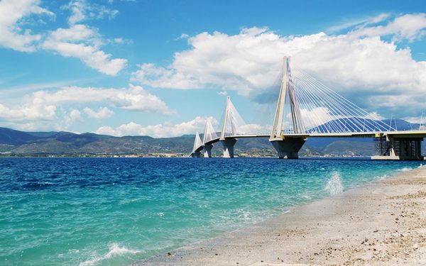 A white bridge going across the water